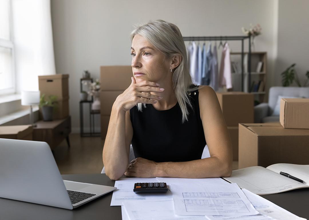 A business person thinking of finances at a home office. 