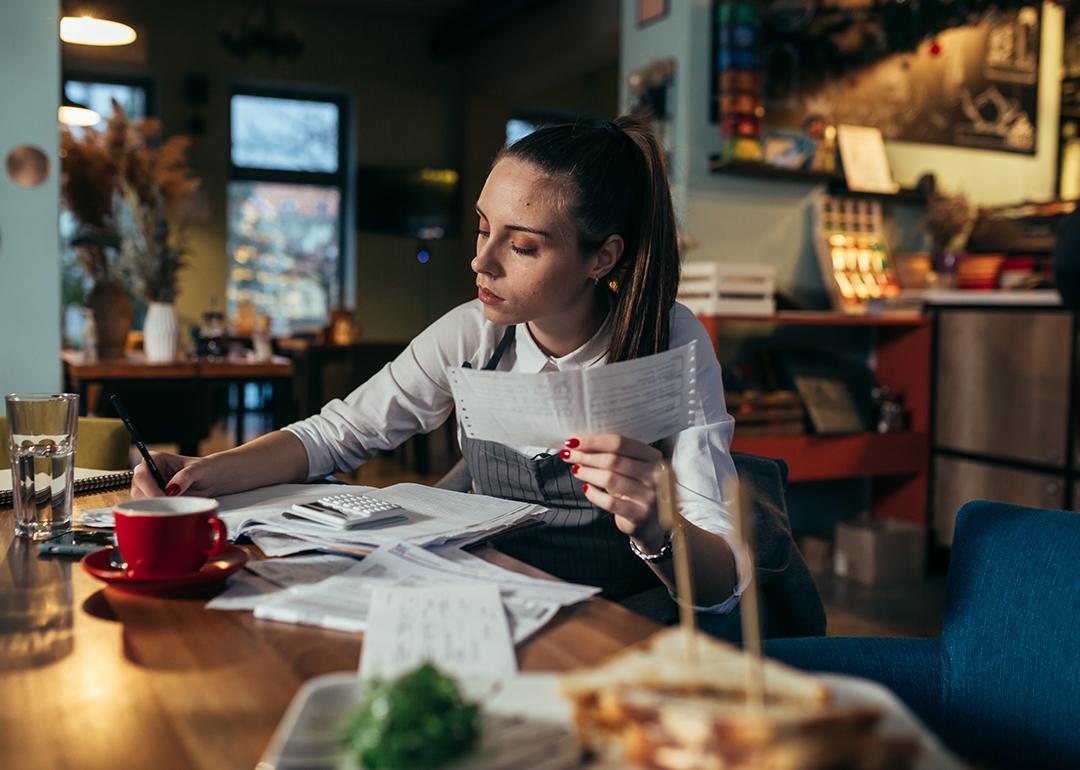 A female restaurant manager reviewing finance reports.