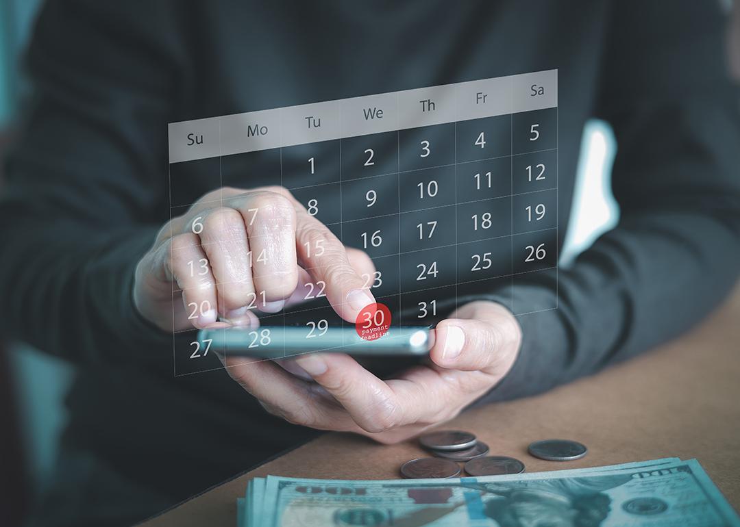 A person using a smartphone to check a virtual calendar.