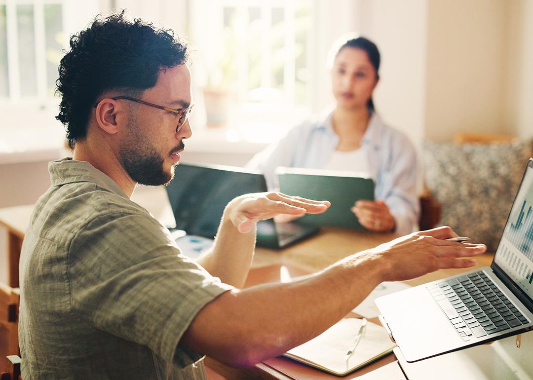Teammates coworking during a conversation on cash management.