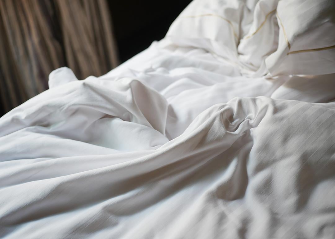 Soft white bedding on a cozy bed.