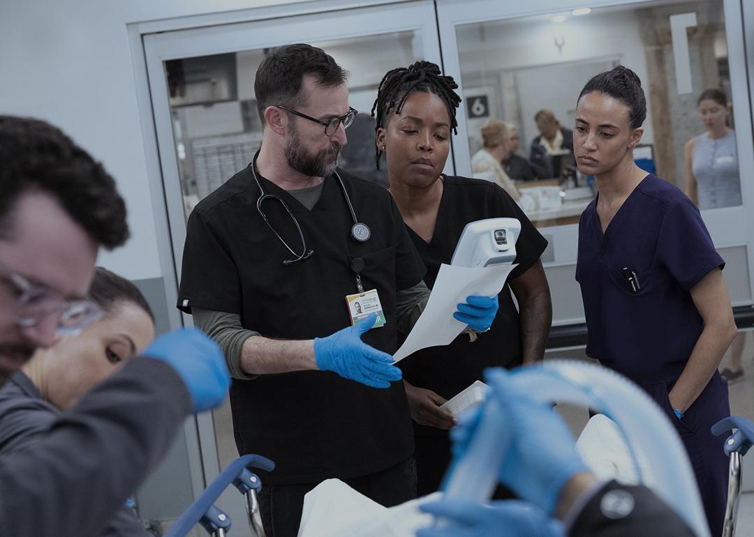 Noah Wyle, Ayesha Harris, and Alexandra Metz in a promotional still for season two, episode 13 of The Pitt.