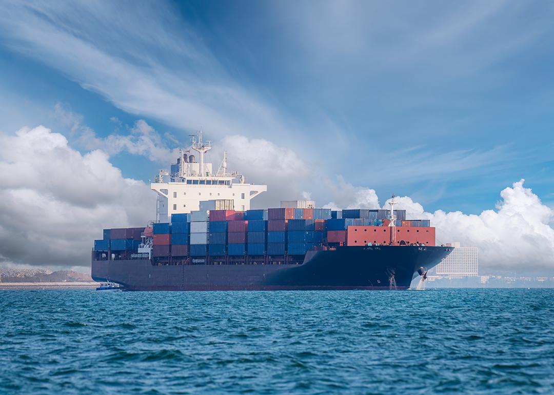 A cargo ship on open blue sea.