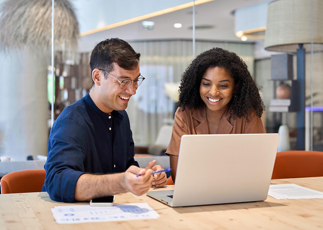 Coworkers working together on a task in an office.