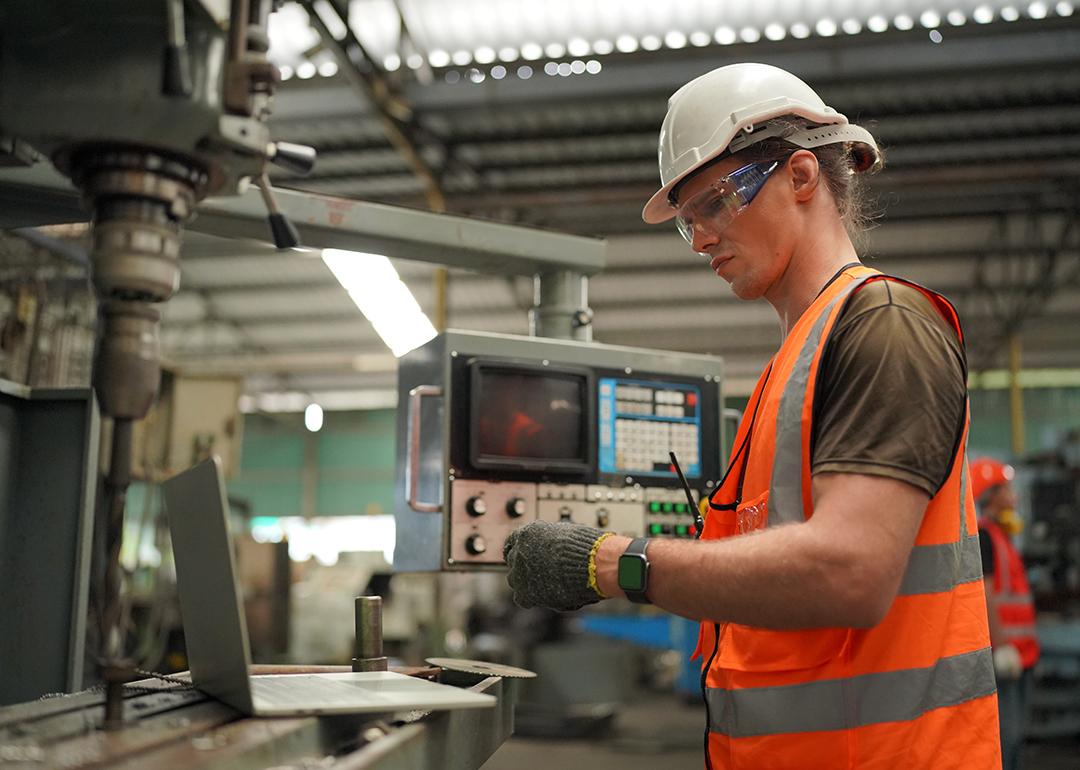 An industrial engineer working inside a manufacturing factory.