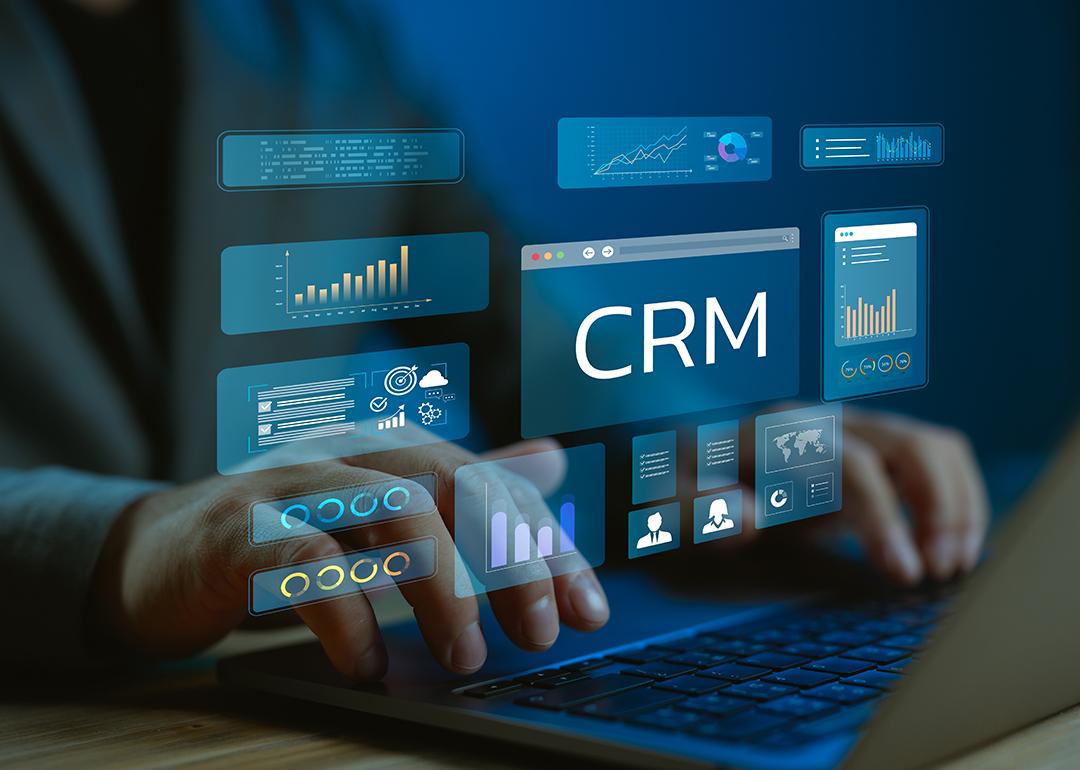 A data analyst utilizing CRM (Customer Relationship Management) system and dashboard from a work laptop.