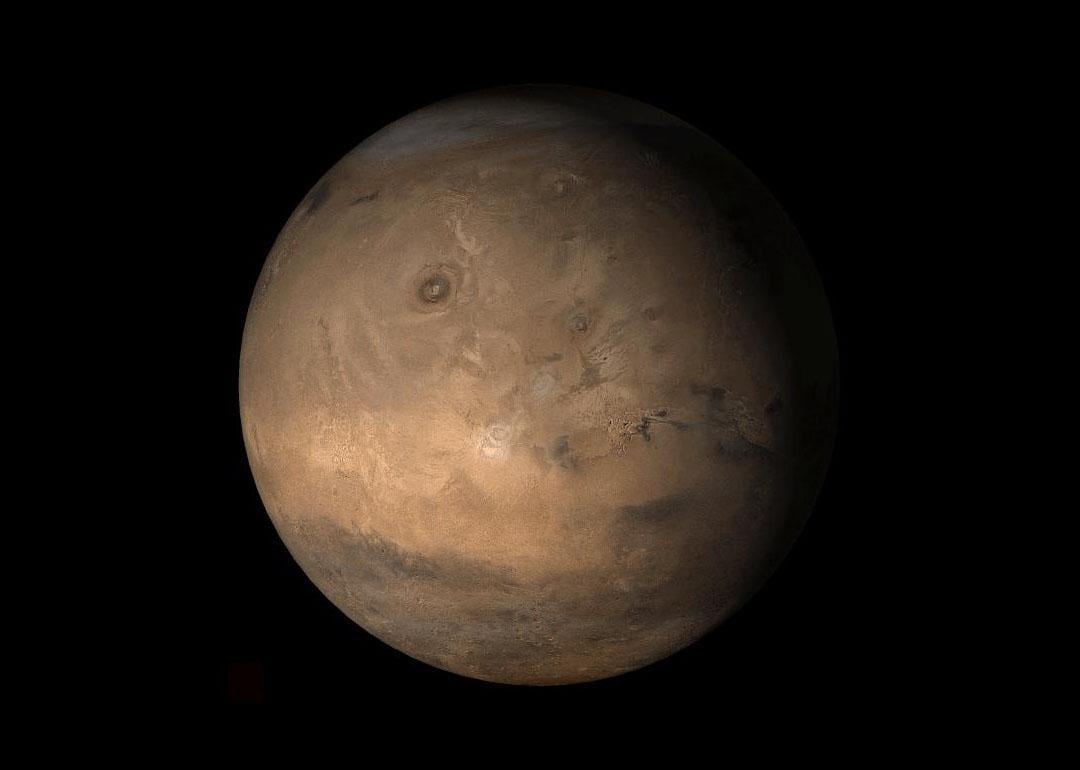 An Image from NASA showing the Tharsis face of Mars, a vast volcanic plateau centered near the equator in the western hemisphere of the planet.
