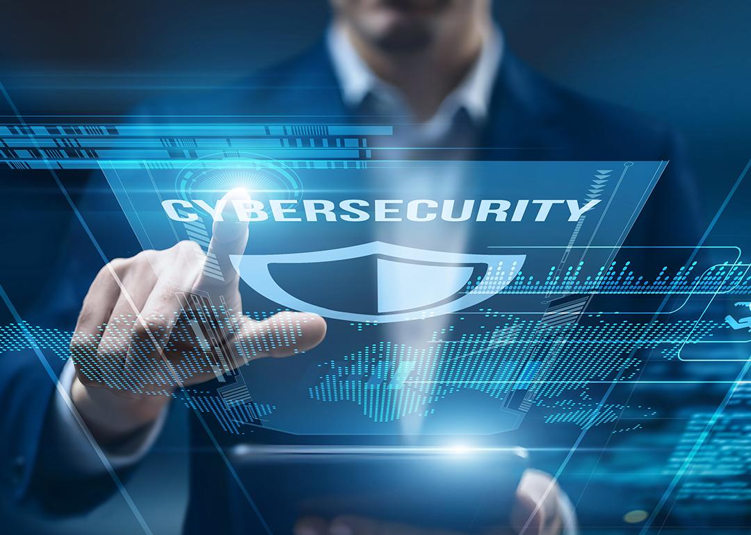 A cybersecurity analyst using a smart tablet for performance monitoring.