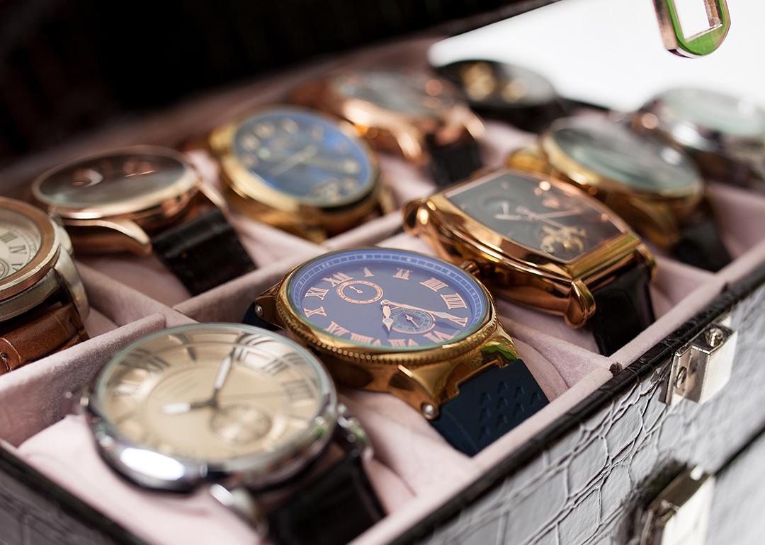 A set of men's luxury wrist watches in a storage box.