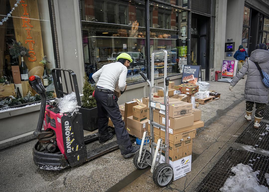 Delivery staff arrange provisions to a bakery in New York City.