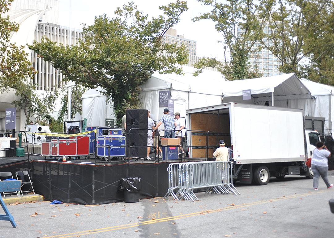  Workers build a backstage entrance at tents during a New York Fashion Week event.