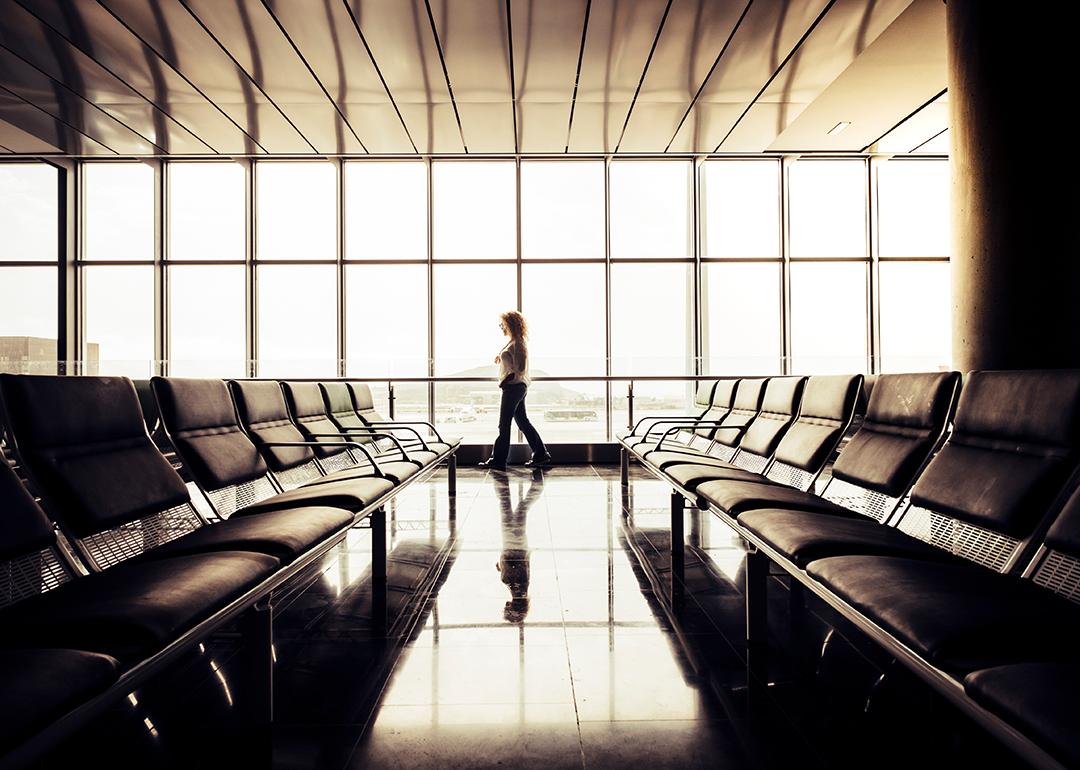 Woman waiting by the departure gate area in an airport.