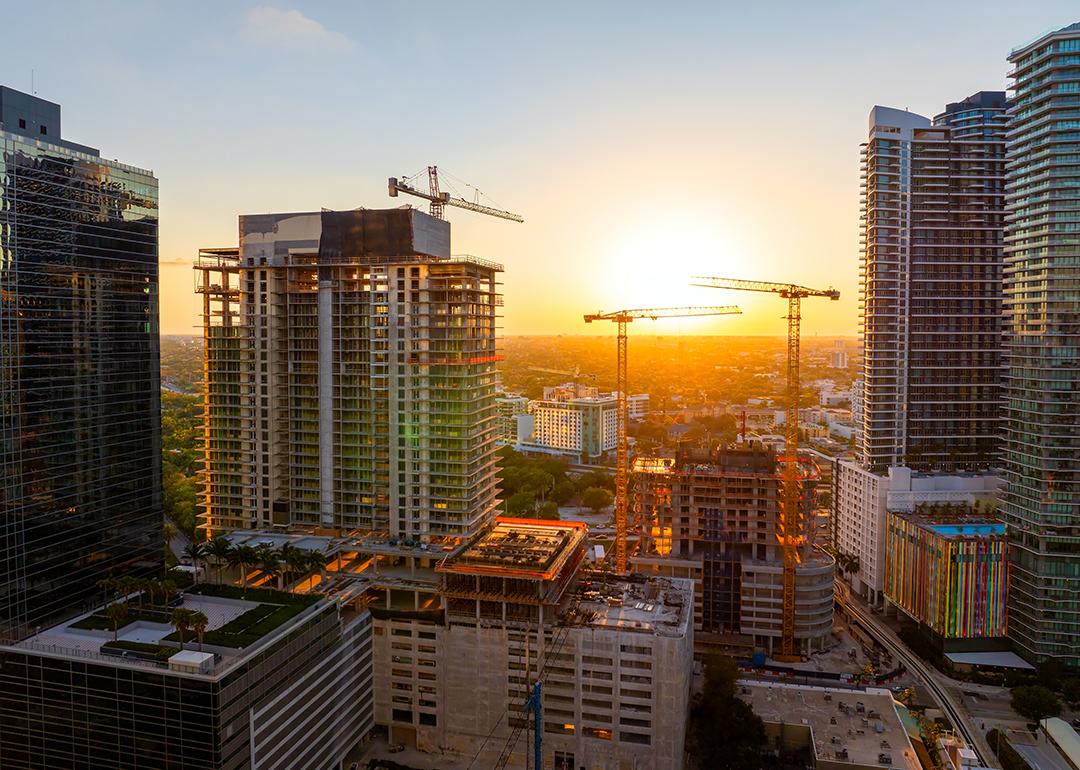 Aerial view of tower cranes at an industrial construction site in Miami, Florida.