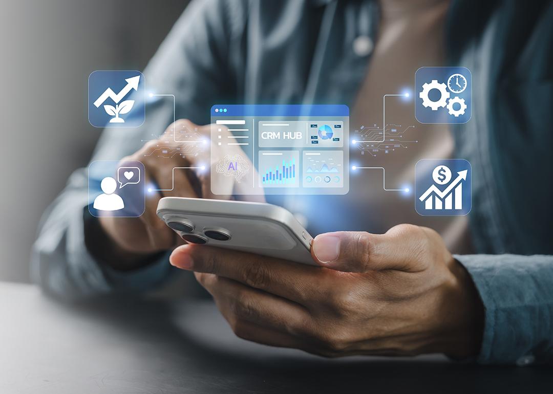 Person using smartphone illustration with CRM system graphics.