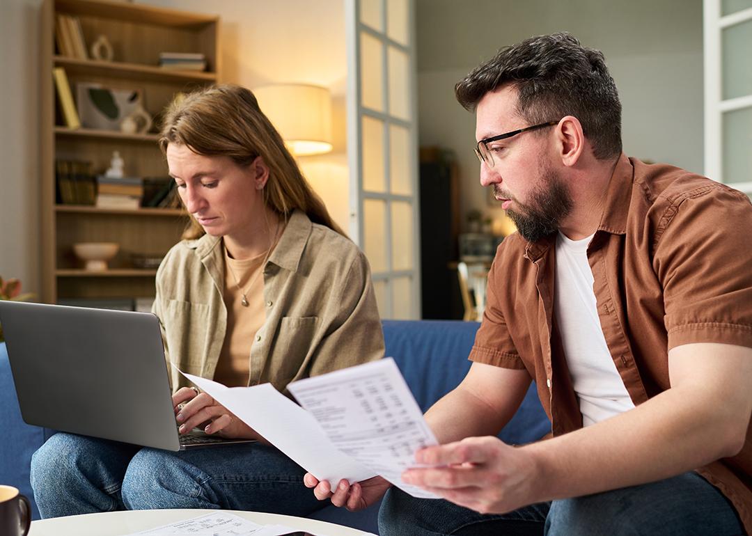 Couple at home organizing tax documents.