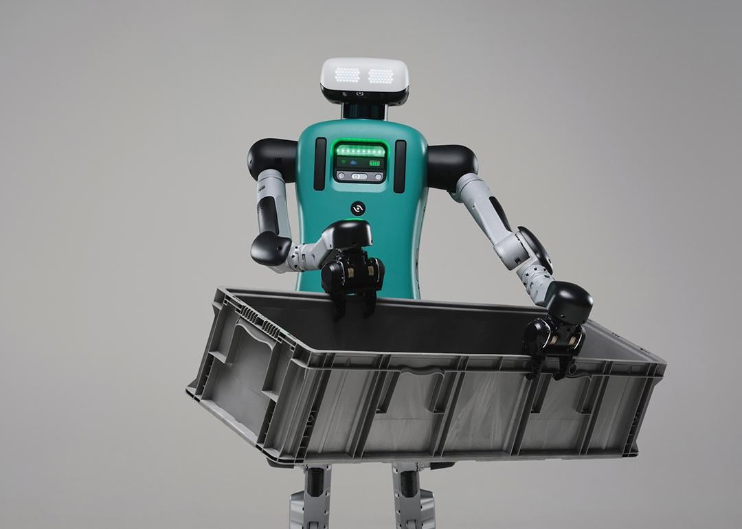 Digit the robot carrying a black crate.