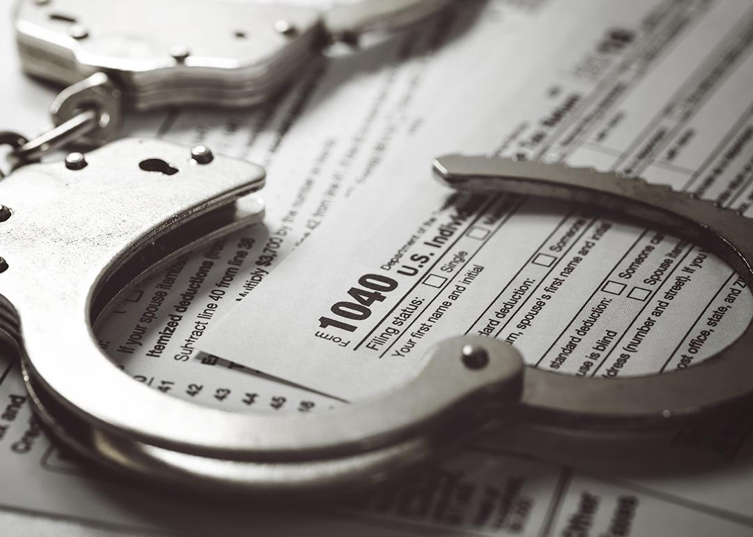 Handcuffs over U.S. tax 1040 forms.