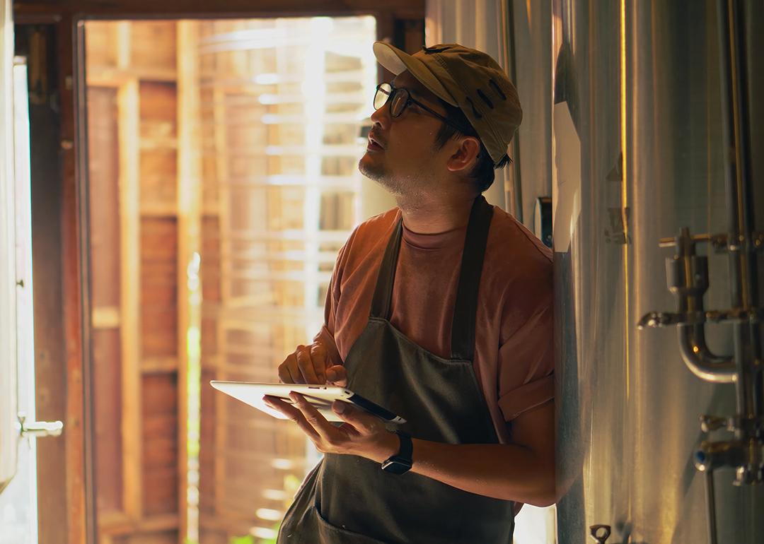 A male business owner checking craft brewery factory systems.