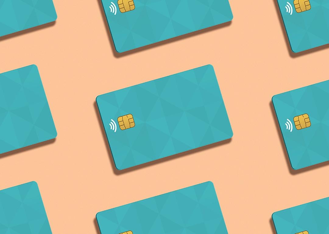 Teal credit cards against a peach background.