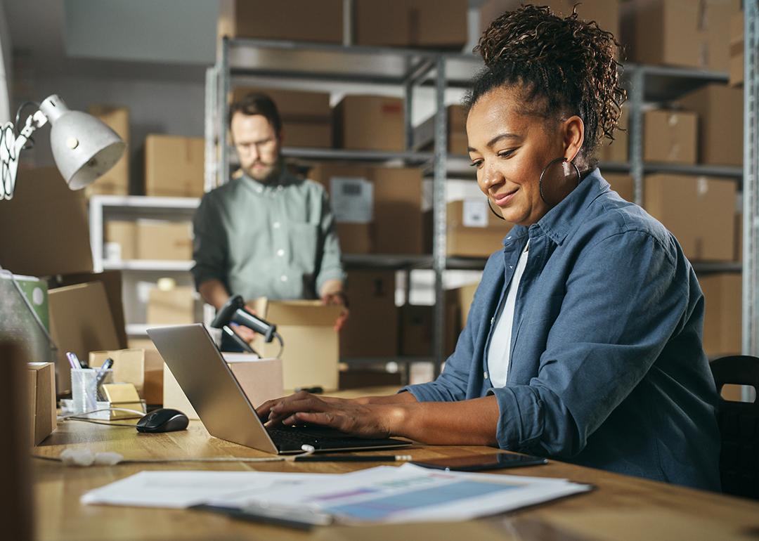 Retail managers check inventory stocks in a warehouse. 