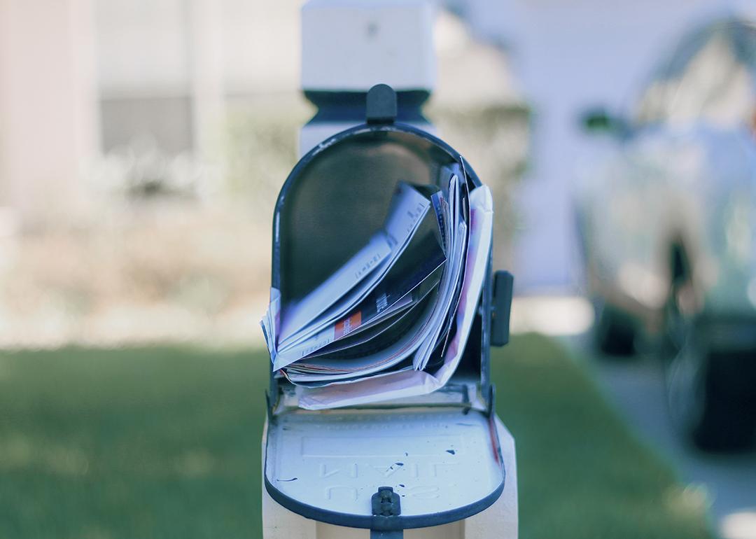 An opened mail box full of letters.