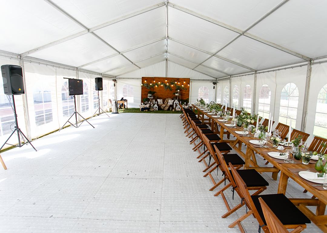 An events tent set up with a long table for a festival.