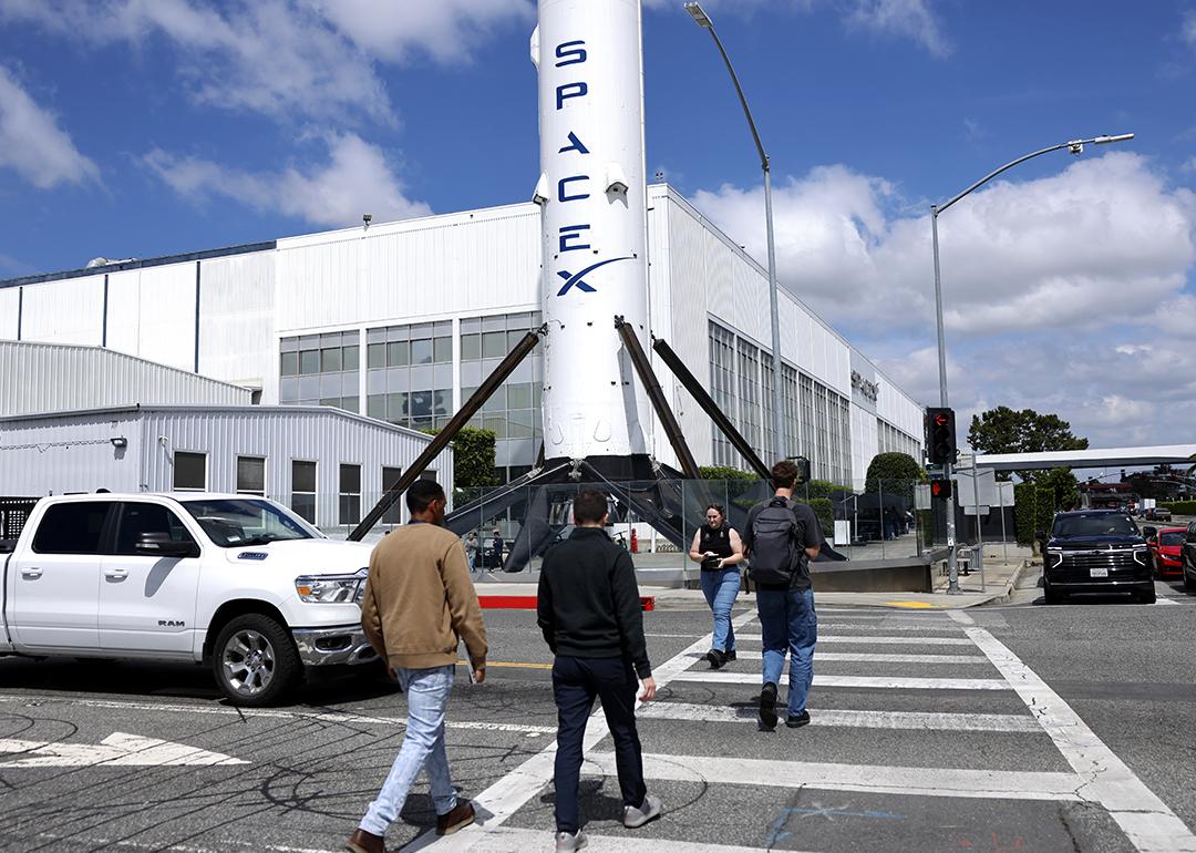 People walk outside a SpaceX facility in Hawthorne, California.