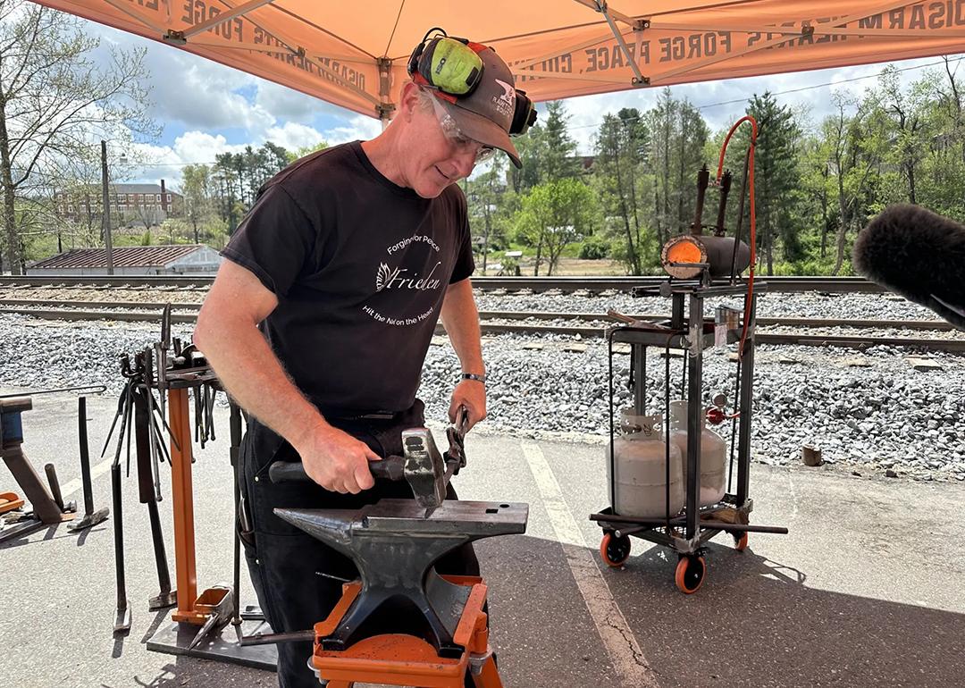 Scotty Utz, RAWtools South’s blacksmith, leads a demonstration at the 2025 Fire on the Mountain Festival in Spruce Pine, North Carolina.