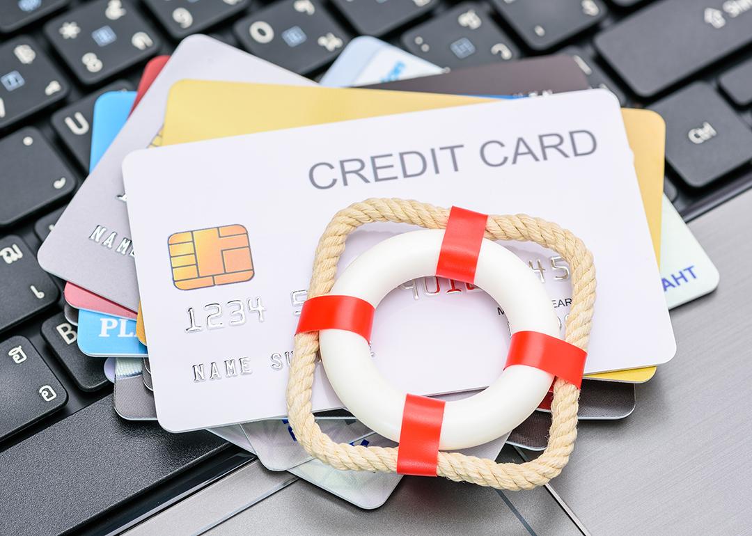 A small red lifebuoy on top of credit cards.
