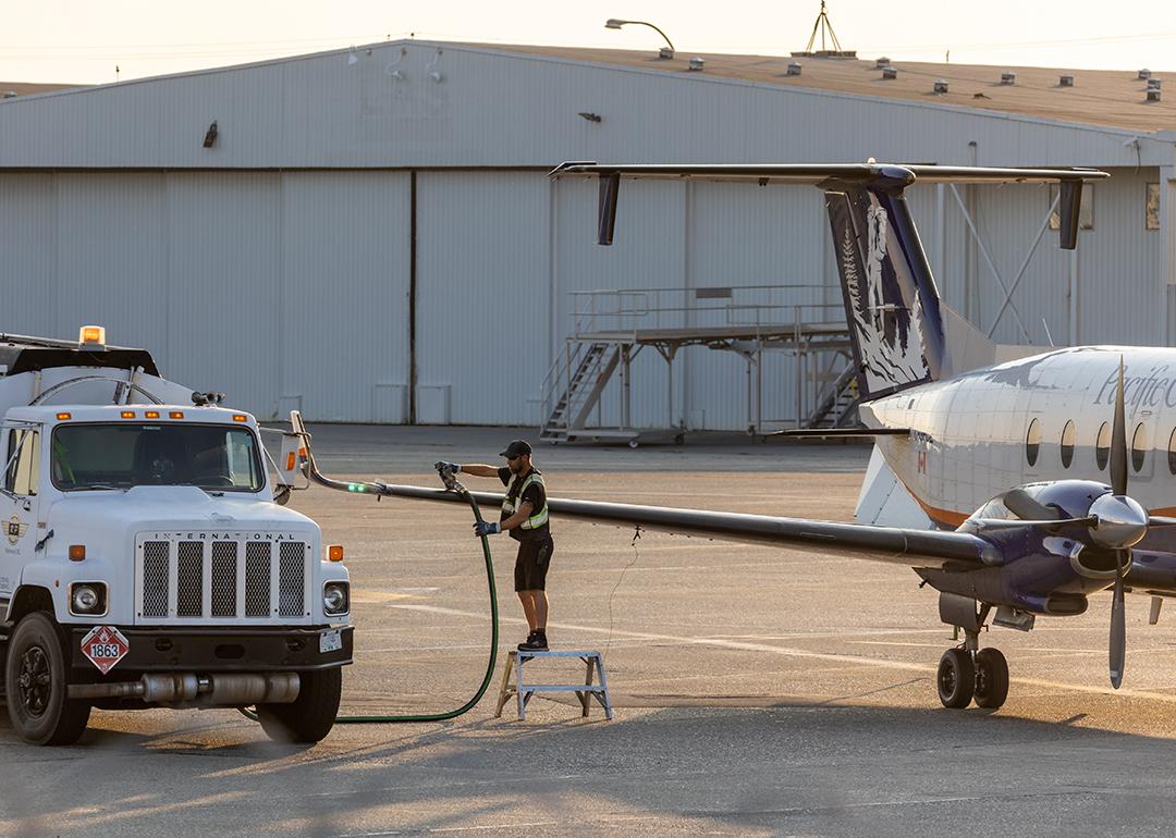 Aircraft staff refuels a private plane.