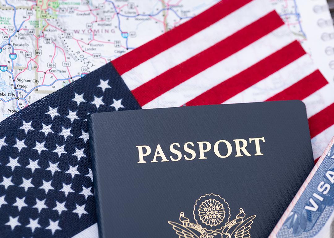 A U.S. passport on top of a U.S. flag and travel map.
