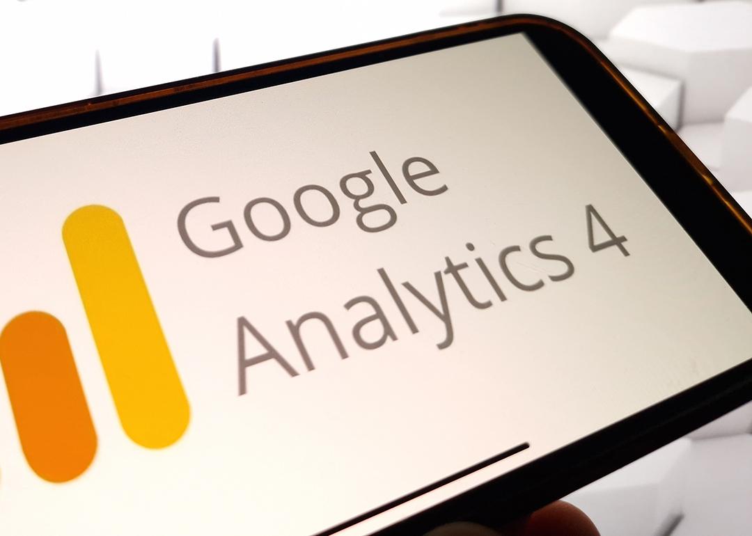 The Google Analytics 4 platform logo displayed on a smartphone.