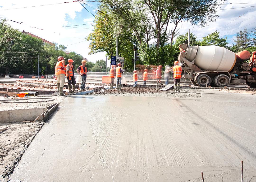 Construction workers doing road works and tram tracks repair. 