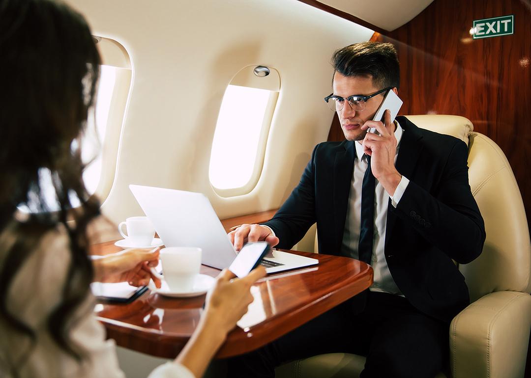  Businessman on a call while on a private flight.