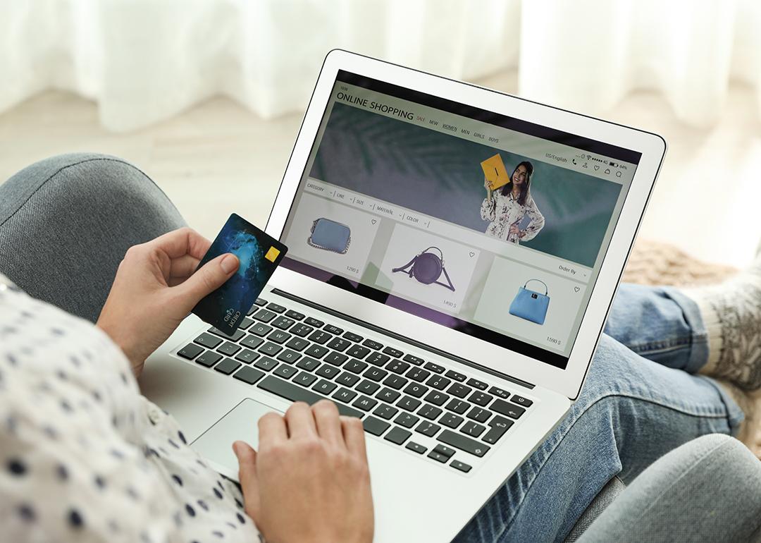 A person using a credit card as payment method for online shopping. 
