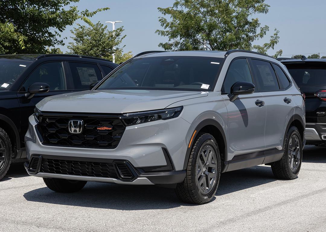 A gray Honda CR-V Hybrid AWD TrailSport compact SUV displayed at a dealership.