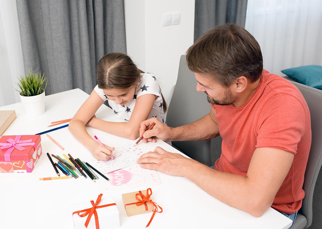 A father and daughter do arts and crafts for Mother's Day.