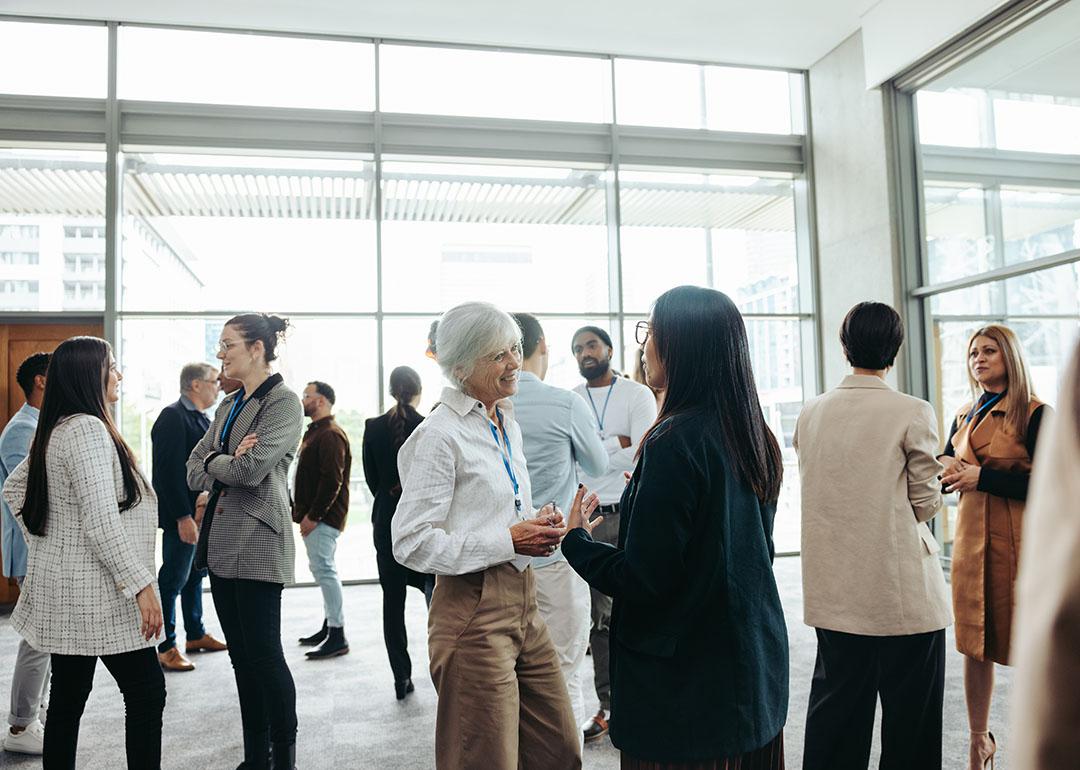 A diverse group of professionals networking at an event.