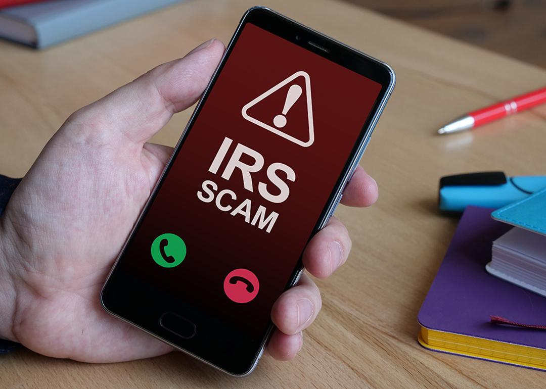 An Internal Revenue Service (IRS) scam call is displayed from a smartphone.