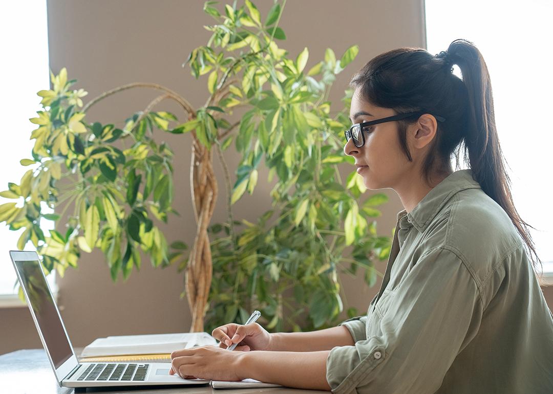 A female remote teacher working from home.