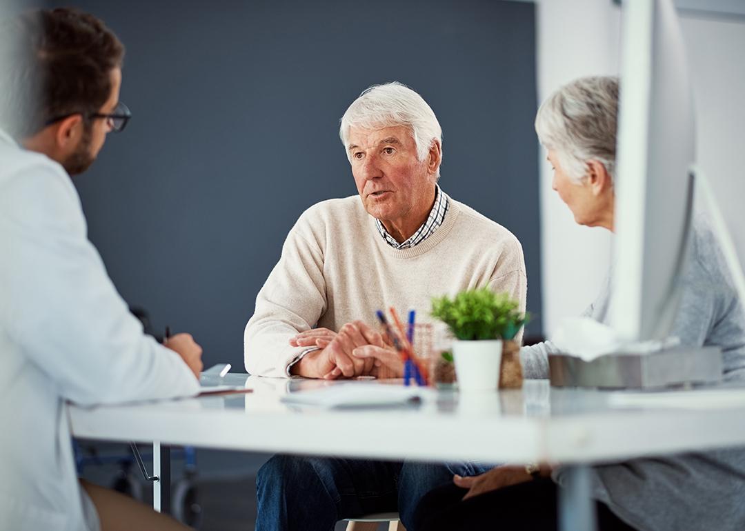A senior couple consulting with a doctor for a health checkup. 