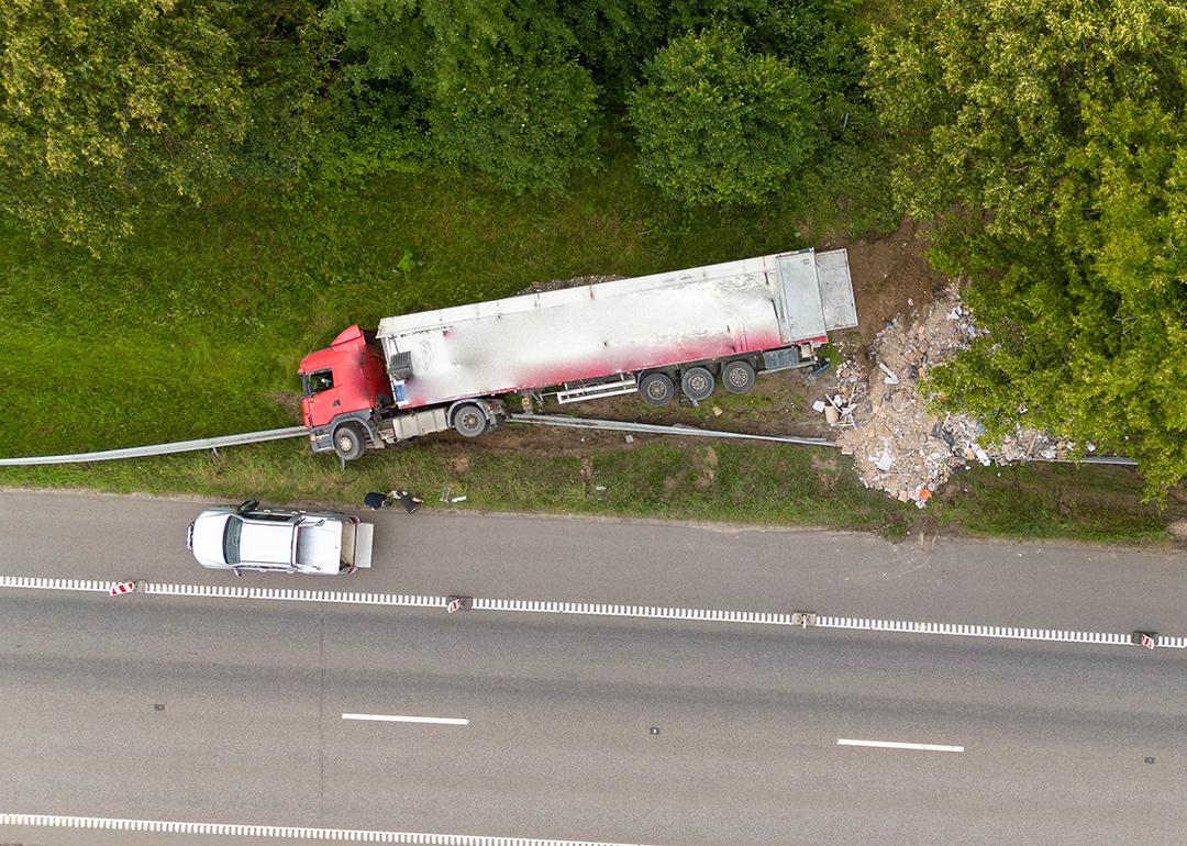 An aerial view of a truck accident scene on a highway.