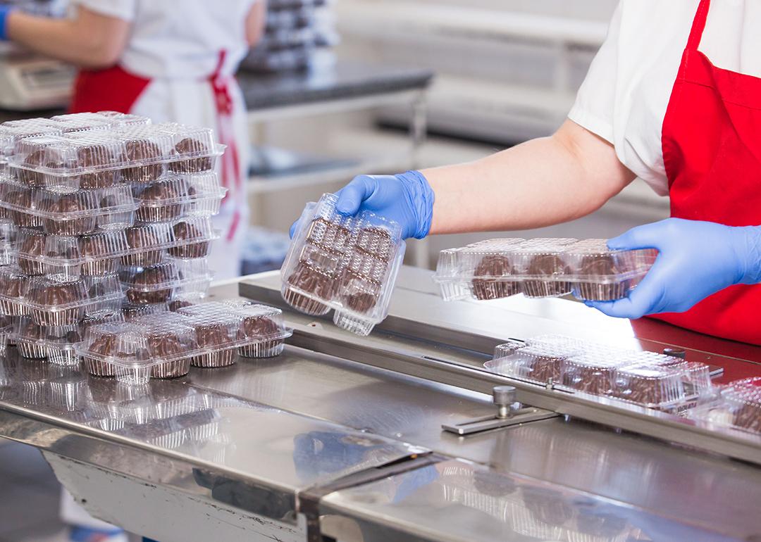 A production worker checking cake balls and confectionary products in an enterprise.