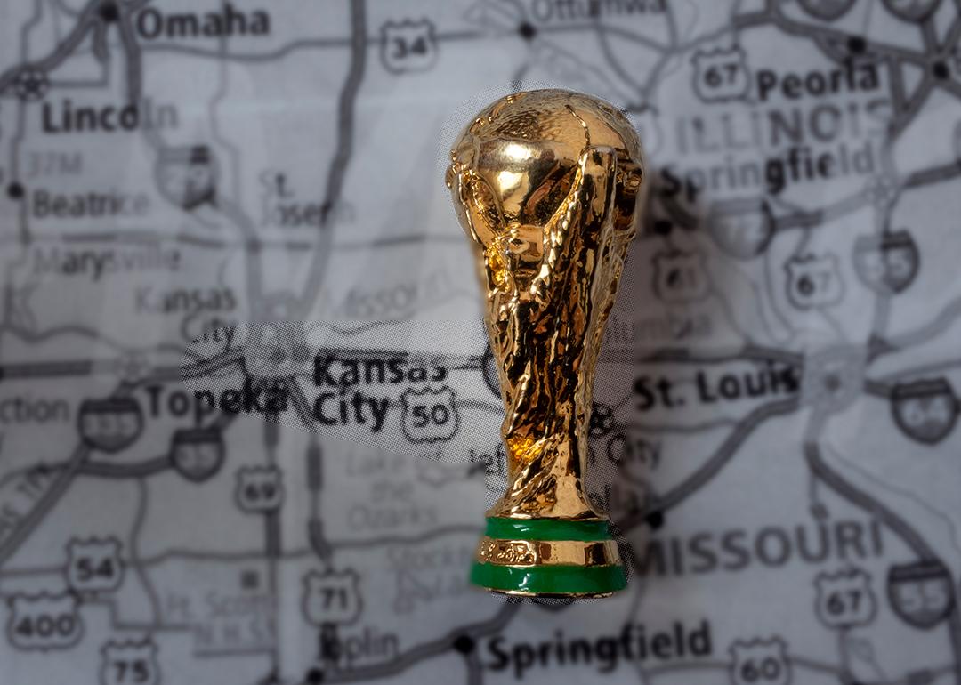 A miniature golden FIFA World Cup trophy on top of a map focused on Kansas City where the 2026 games will be held.