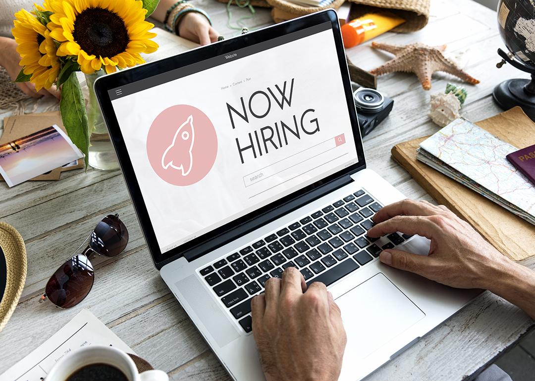 A person checking job opportunities online from a laptop. 