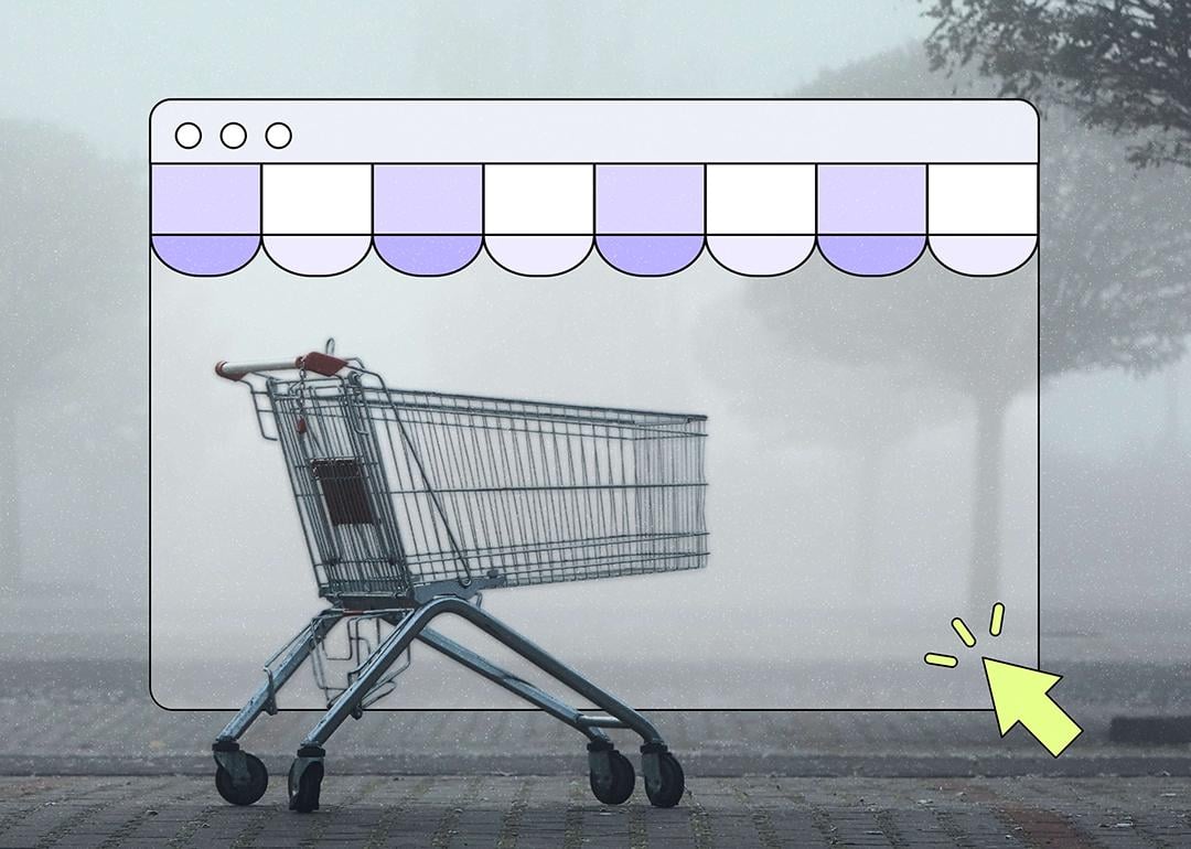 A shopping cart sits alone on a foggy, misty street, framed inside an illustrated browser window with a purple scalloped storefront awning. A yellow cursor arrow points toward the bottom right corner of the browser frame.