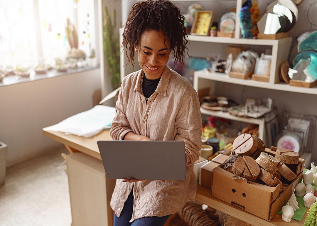 A decorator checking work online in her own art studio.