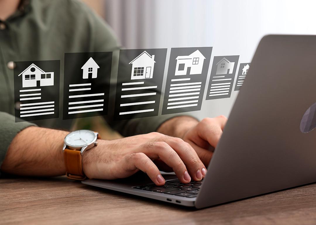 A person choosing residential home options from a laptop at home.