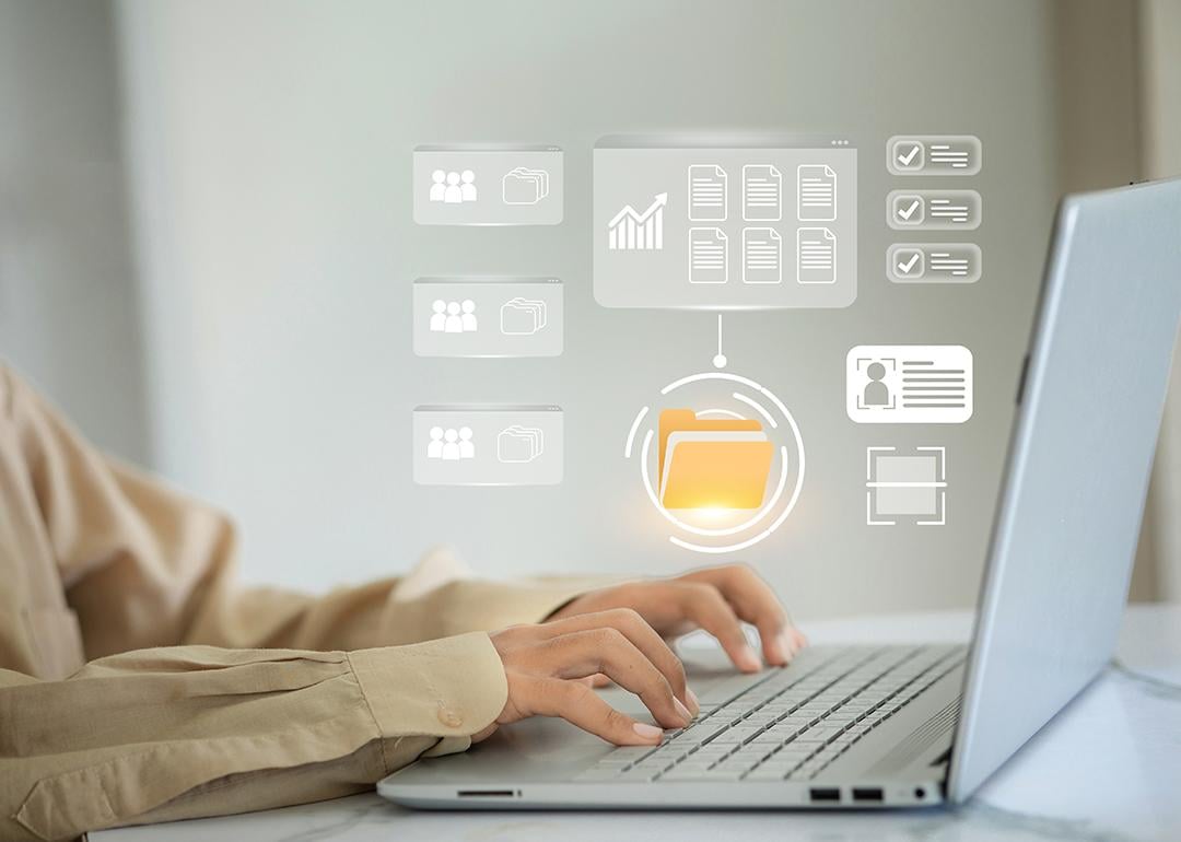 A person checking through virtual file folders from a laptop.