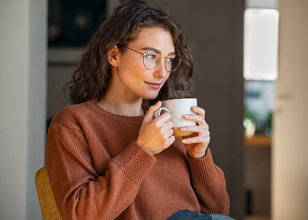 A person drinking coffee while relaxing at home.